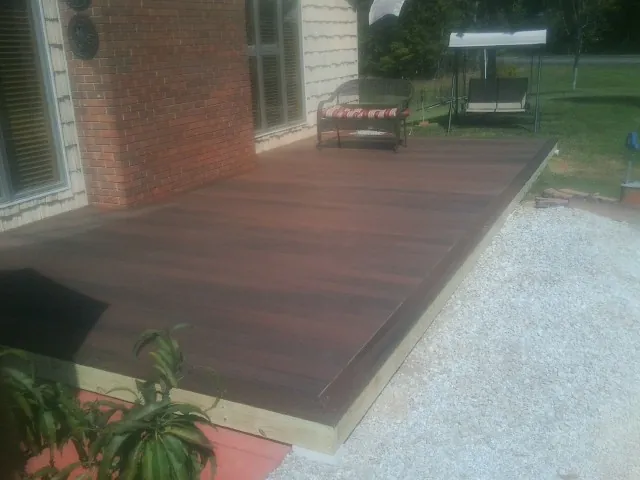 Freshly stained wood deck built against a brick home in Miami